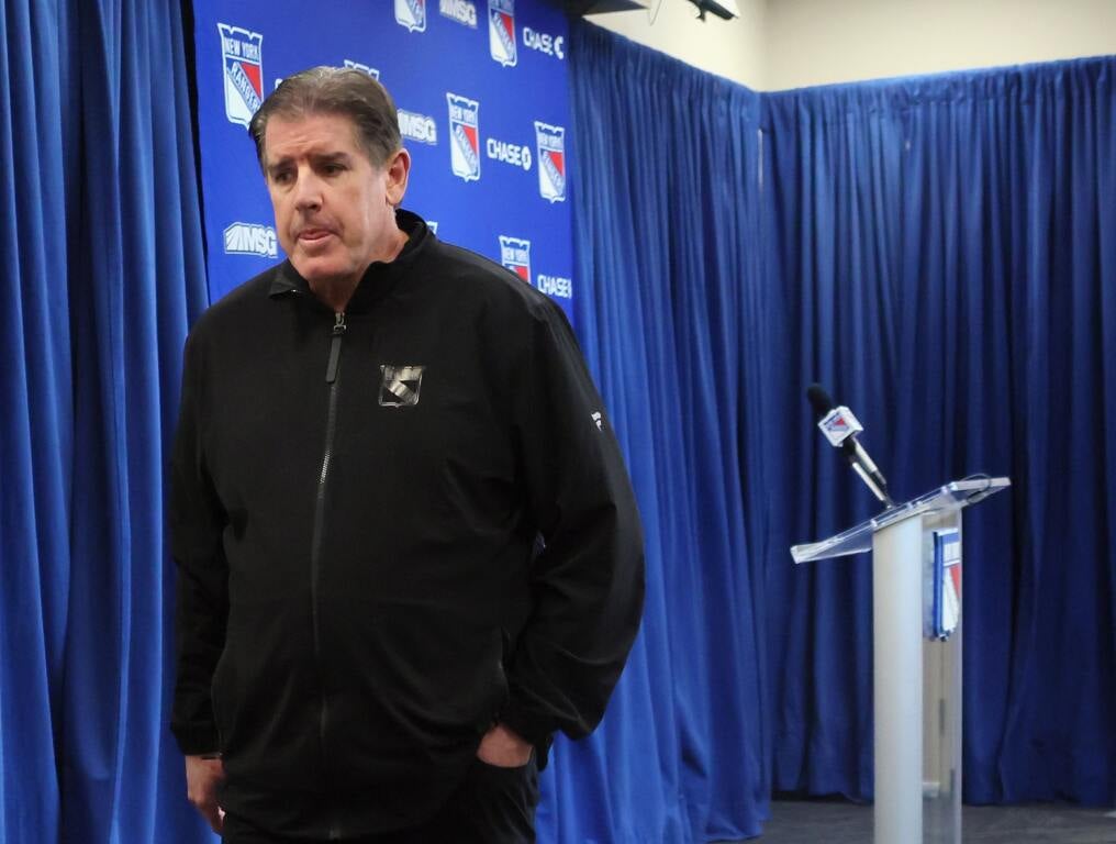 Rangers coach walks off after press conference. 