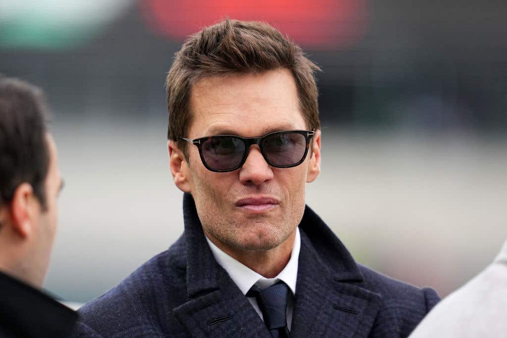 Former player Tom Brady looks on prior to the NFC Championship Game