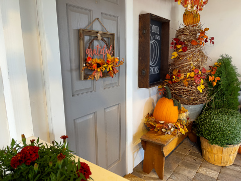 Front porch decorated for autumn.
