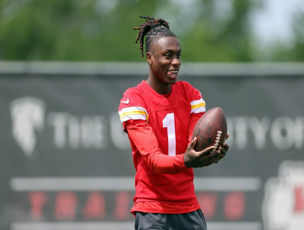 Xavier Worthy catches a football.